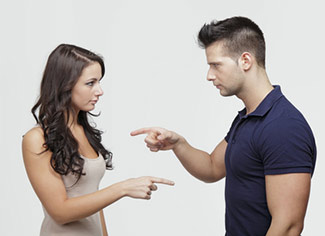 Couple pointing at each other